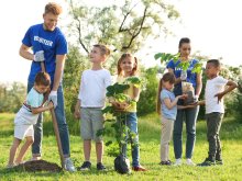 Diverse children volunteer planting trees